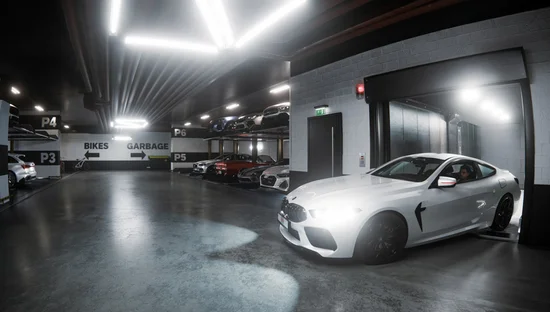 Car leaving a car lift in an underground car park, with car stackers in the background