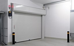 Car lift with roller shutter in the shaft headroom.